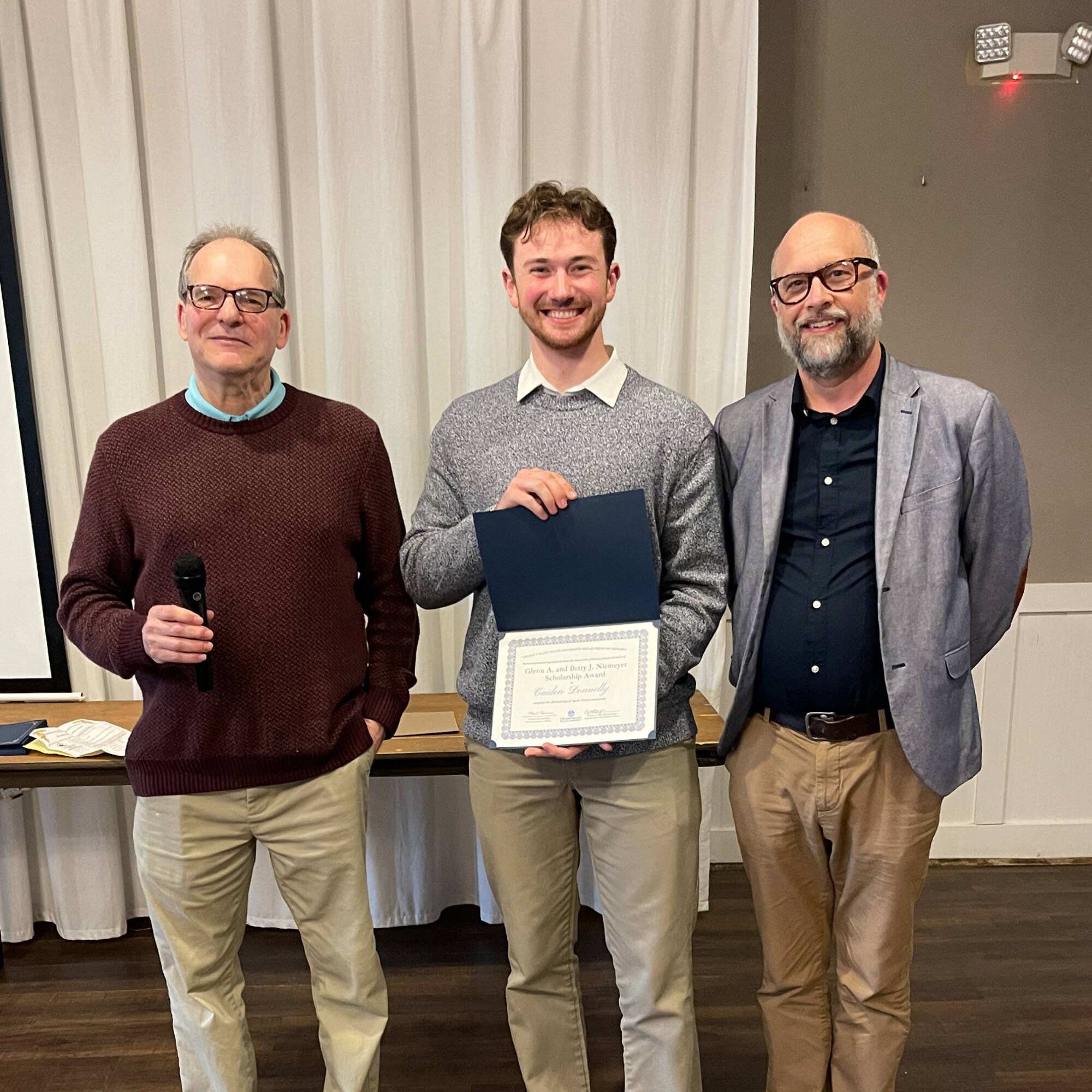 Caiden Donnelly holding award with professors Montagna & Huner